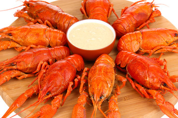Tasty boiled crayfishes on chopping board close-up