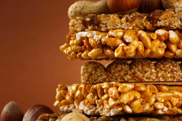 tasty sweets (kozinaki), on brown background