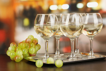 White wine in glass on room background