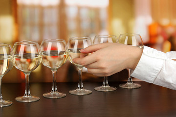 Tasting white wine on room background