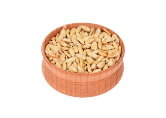 Sunflower seeds in wooden bowl, isolated on white background