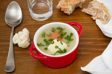 vegetable soup in the bowl with bread and spoon