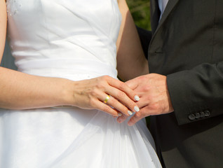 bride and groom holding hands after wedding show there rings