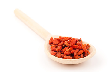 wooden spoon with goji berries isolated on white