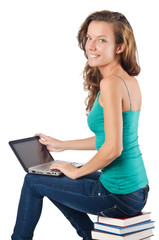 Student with netbook sitting on books