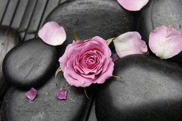 rose and zen stones on mat