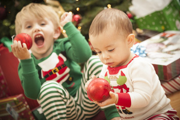 Fototapeta na wymiar Mixed Race Baby and Young Boy Enjoying Christmas Morning Near Th