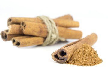 A bundle of tied cinnamon sticks on white background