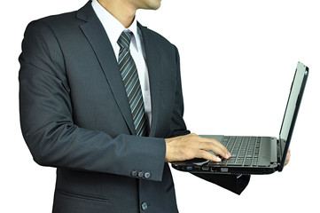 Businessman holding and typing laptop computer
