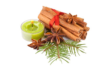 candle, cinnamon, anise and fir branch isolated on white