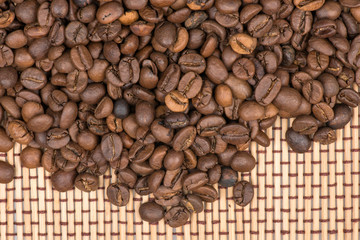 Coffee beans on wooden mat