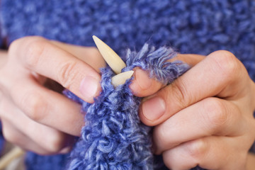 Human hand knitting needles