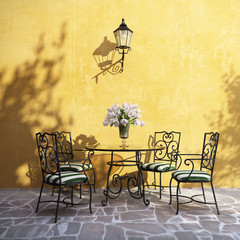 Romantic aged Italian village outdoor furniture on stucco wall