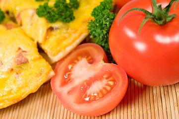 Pizza with tomatoes and parsley close up