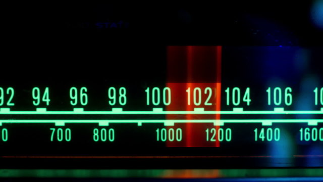 a glowing radio with the marker running through stations