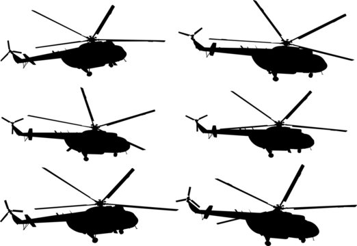 Set of silhouettes of flying helicopters