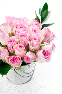 Pink rose bouquet in a bucket on a white background