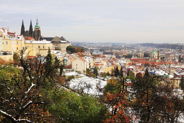 Obraz premium Snowy colorful autumn Prague with gothic Castle, Czech Republic