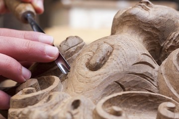 craftsman carving with a gouge