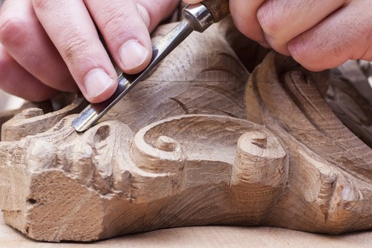 craftsman carving with a gouge