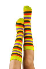 female legs in colorful striped socks isolated