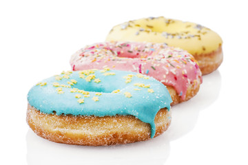 Three glazed donuts isolated on white background