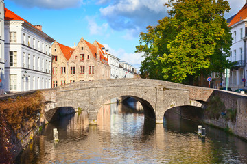 Beautiful view of a canal and , bridge, red roofs in Bruges, Bel
