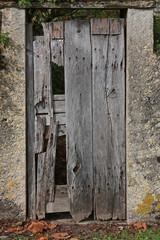 Broken wooden doors of an old stable