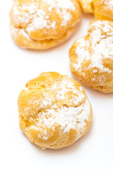Cream puffs sprinkled with powdered sugar