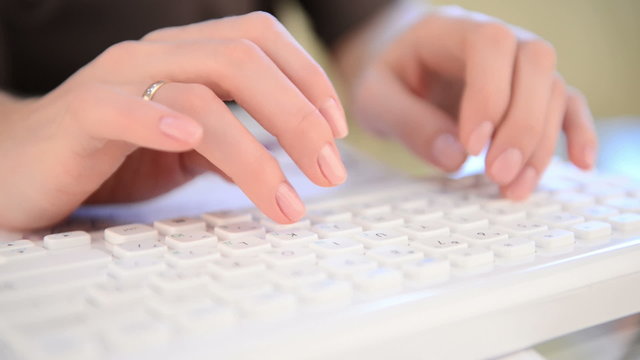 Typing on keyboard. Woman hands, close view