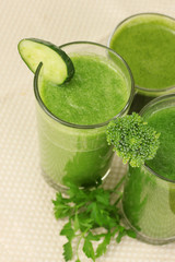 Three kinds of green juice on light background