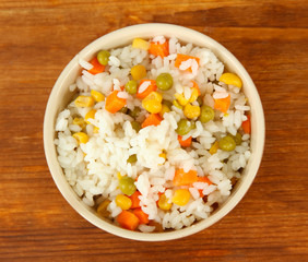 Risotto in bowl on wooden background