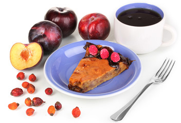 Tasty pie on blue plate with plums isolated on white