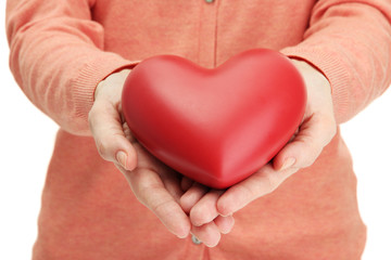Fototapeta premium Red heart in woman hands, close up