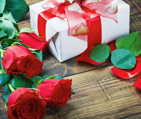 red roses and holiday gift