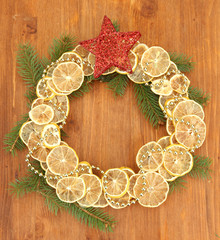 christmas wreath of dried lemons with fir tree and star,