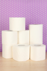 Rolls of toilet paper on purple with dots background