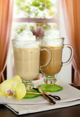 Fragrant coffee latte in glasses cups with vanilla pods,