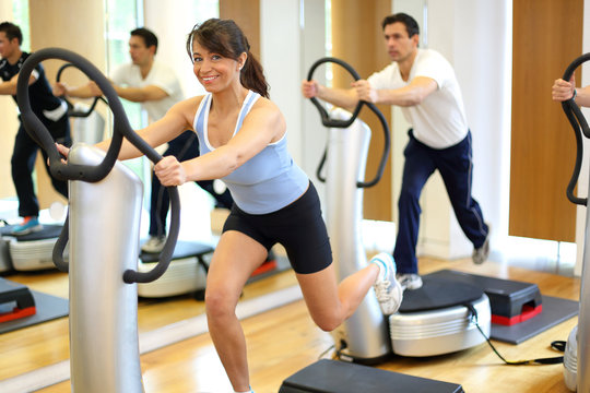 Woman on vibration plate in a gym