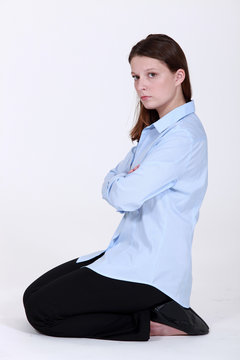 woman kneeling down cross-armed looking sulky