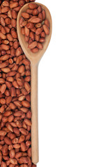 Obraz premium Peanuts nuts in a wooden spoon
