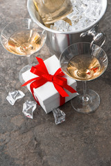 two glasses, bottle of champagne and gift box