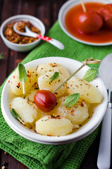 Potatoes boiled with spices and pickled tomatoes