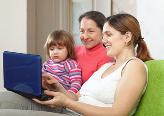 Fototapeta na wymiar Family of three generations with laptop
