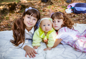 Fototapeta premium Happy little sisters in park