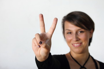 girl making peace sign