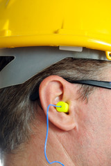 yellow earplug into the ear