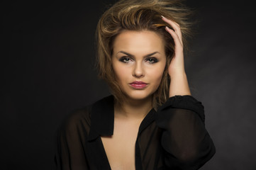 Fototapeta premium Beautiful woman with a windblown hairstyle