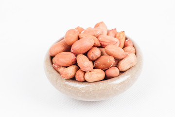 Peanuts in bowl on white