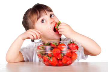 A child with a bowl fresh strawberries